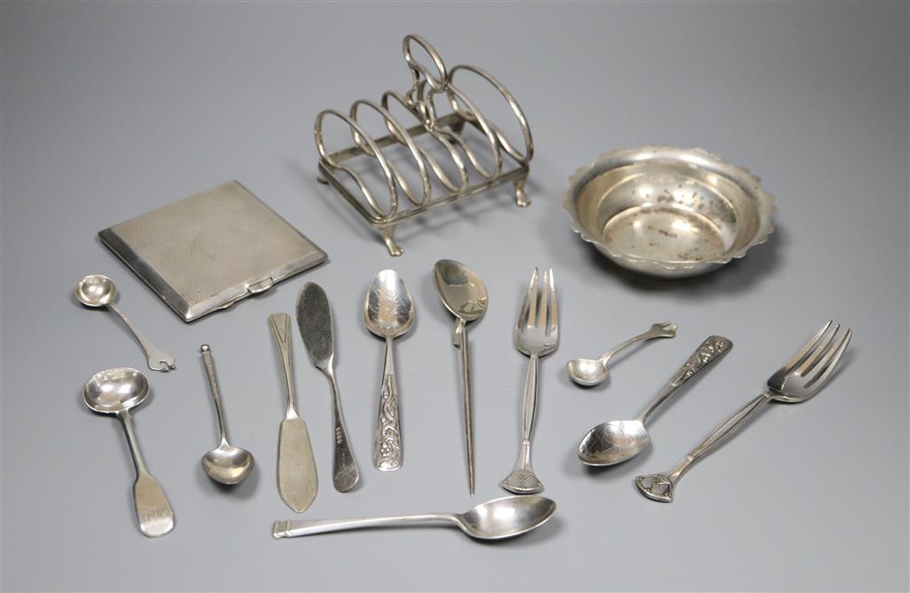 An early 20th century silver toastrack, a silver bowl, silver cigarette case and minor flatware including silver and plated.